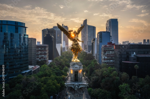 Aerial view of the majestic Angel de la Independencia monument surrounded by skyscrapers at sunset, Cuauhtemoc, Mexico City, Mexico.