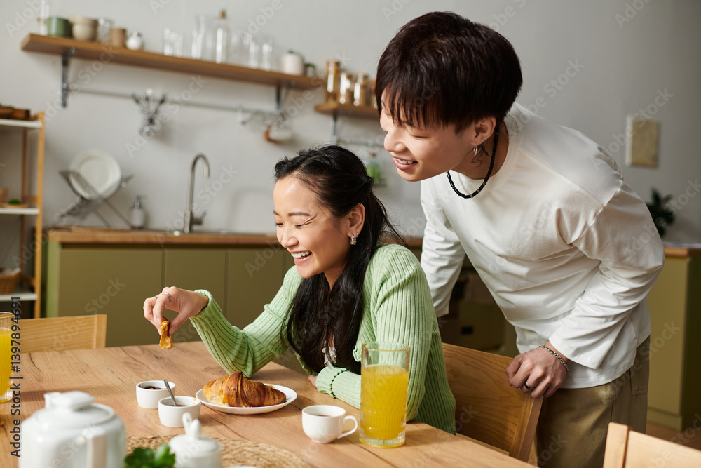 Joyful morning together as a young couple enjoys breakfast at home Joyful morning together as a young couple enjoys breakfast at home
