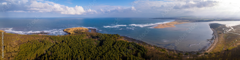 Aerial view of river tyne estuary with serene ocean and picturesque coastline, Dunbar, East Lothian, Scotland, United Kingdom.