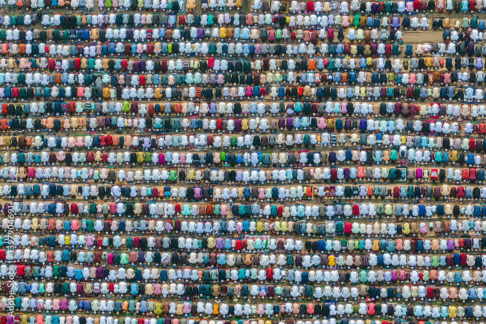 Aerial view of a large crowd gathered for Eid Prayer in a sacred and colorful ceremony, Bogura, Rajshahi, Bangladesh. Aerial view of a large crowd gathered for Eid Prayer in a sacred and colorful ceremony, Bogura, Rajshahi, Bangladesh.
