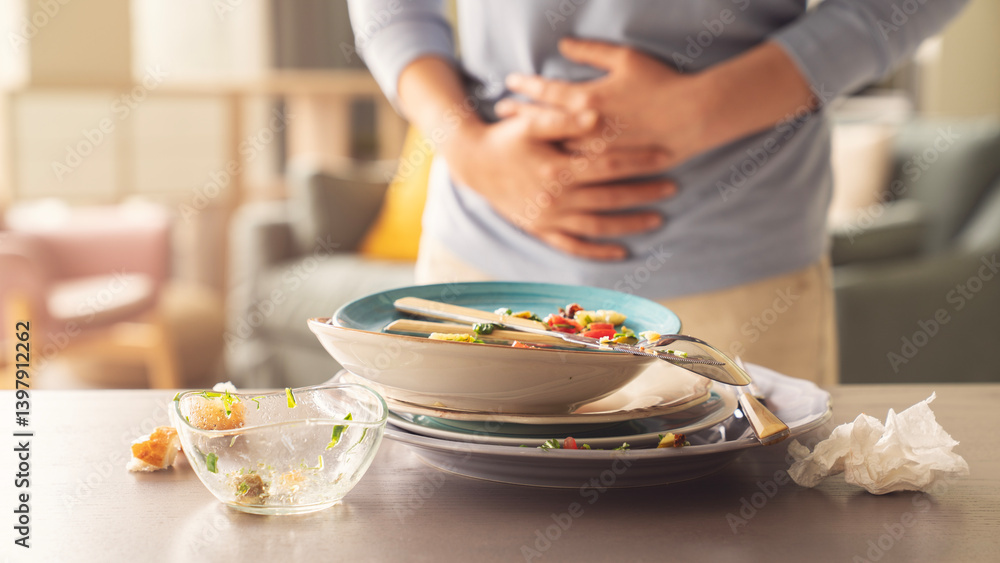 Woman with bloating and stomach ache from overeating Woman with bloating and stomach ache from overeating