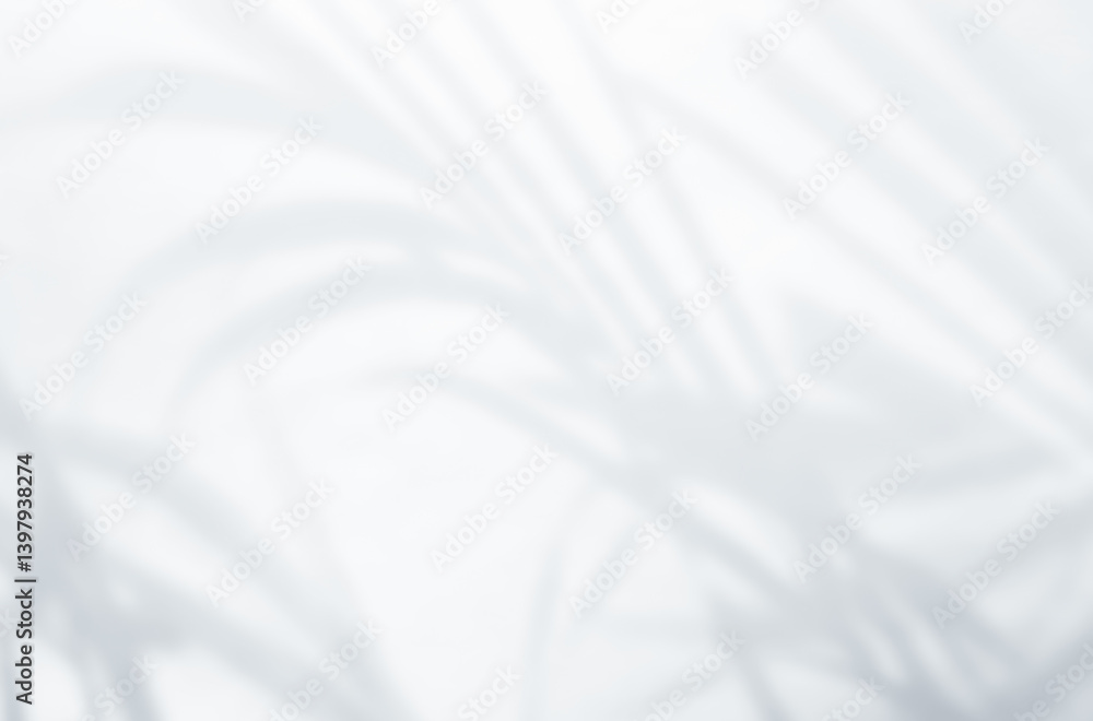 Obraz premium Shadow of leaves tree plant overlay on white wall. Sunlight effect shadow on the wall. Minimal blurred backdrop backgrounds. Summer tropical surface background