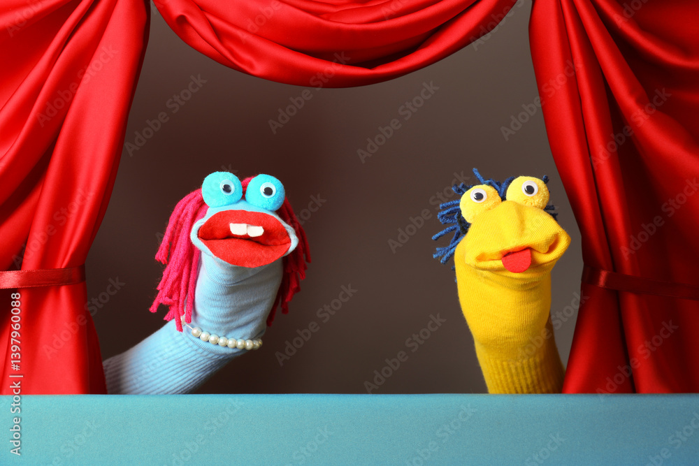 Naklejka premium Creative puppet show on stage with red curtains