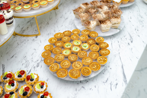 Candy bar. Mini cakes. They are on the dessert table in a rich assortment.