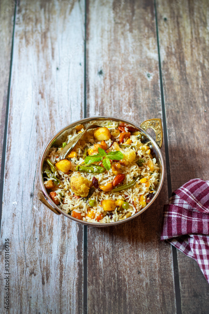Navratan Pulao is a fragrant, colorful rice dish cooked with mixed vegetables, dry fruits, and aromatic spices, often served warm. Navratan Pulao is a fragrant, colorful rice dish cooked with mixed vegetables, dry fruits, and aromatic spices, often served warm.