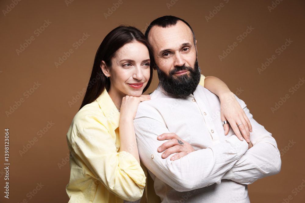 Fototapeta premium Happy daughter and father on brown background