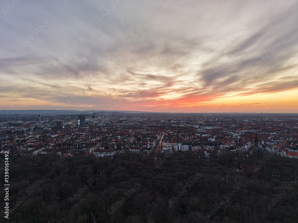 Fototapeta premium Experience the stunning beauty of a sunset over the cityscape with dramatic dancing clouds Hannover Lower Saxony