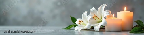 White lily flowers and flickering candles casting a warm glow on a sleek grey background,  decoration,  peaceful