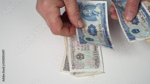 Counting Vietnamese dong banknotes