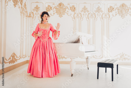 Foto Elegant woman in pink gown by a grand piano in ornate room