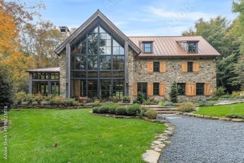 Elegant stone house surrounded by lush greenery and vibrant trees in a tranquil setting, showcasing modern architecture and rich natural beauty