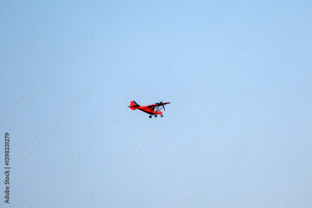 Propeller plane is flying on isolated blue sky Propeller plane is flying on isolated blue sky