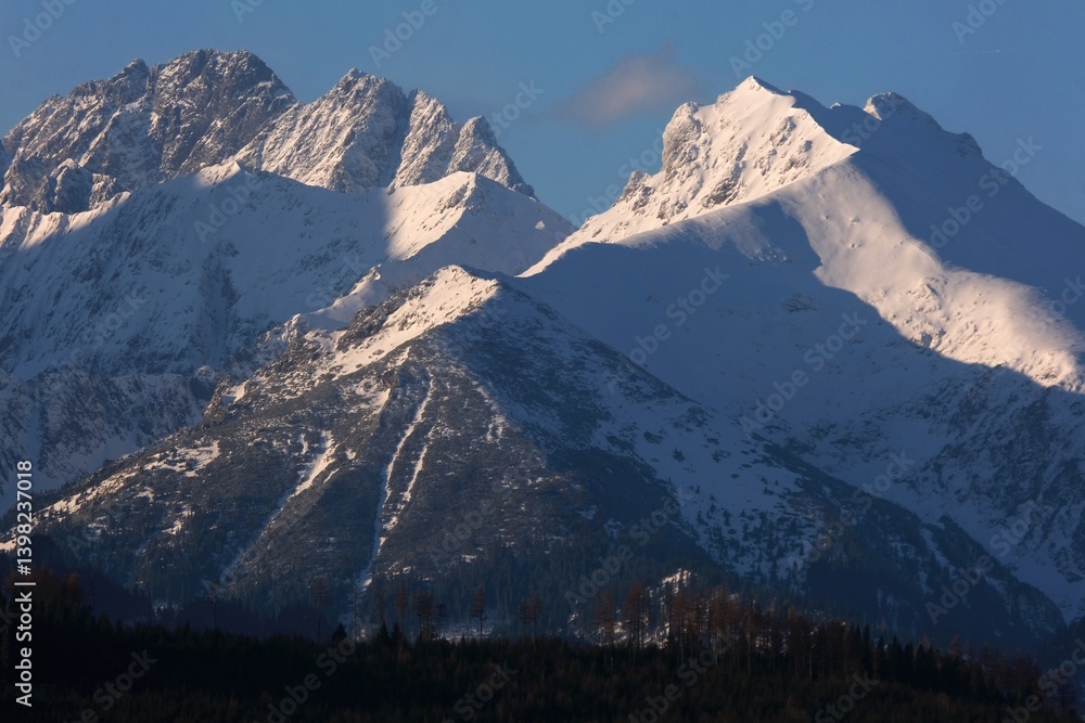 The snow-capped peaks of the High Tatras mountains (with Javorinska Siroka) in sunrise light from viewpoint Pass over Lapszanka (Pass over Łapszanka), Podhale, Poland