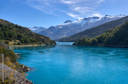 A landscape beauty in the wild Patagonia, a lake of turquoise color, snowy mountains and green forest. Tourism and hiking in Chilean Patagonia along the road 7 Carretera Austral. View on lake Bertrand