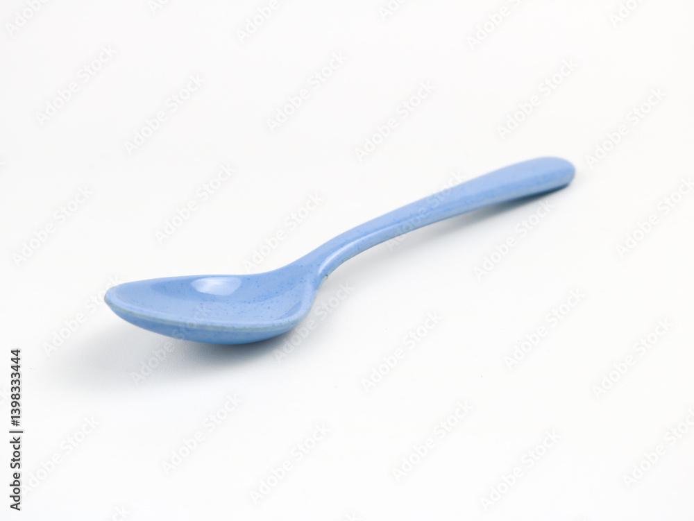 Single blue plastic spoon isolated - on white background Single blue plastic spoon isolated - on white background