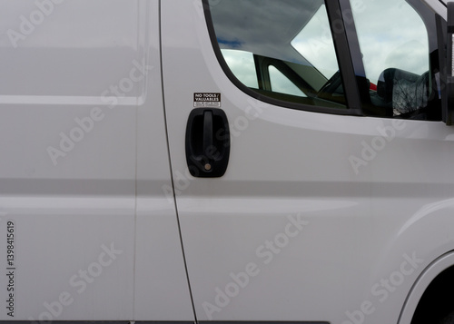 A white van with a sticker on the door that says 