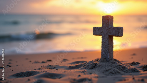 A Christian cross made from sand on a beach at sunset with the sun visible through an archway.