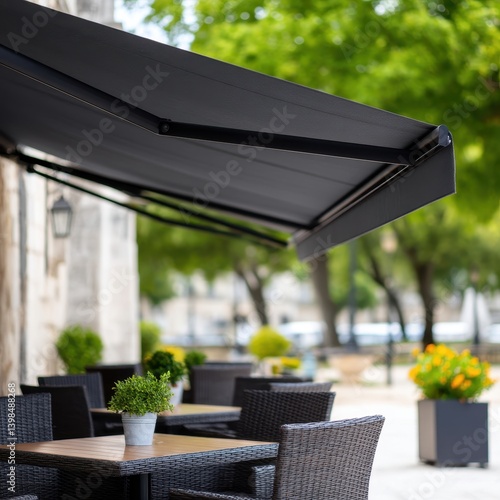 Cozy patio featuring a table and chairs with a sleek retractable awning providing shade for outdoor gatherings
