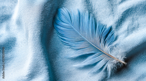 Blue aesthetic wallpaper featuring a single delicate blue feather resting on a soft, light blue velvet background, minimalistic and serene texture design.