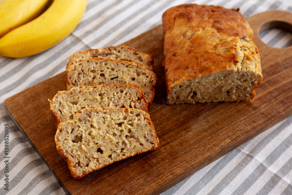 Homemade Banana Bread on a wooden board, side view. Homemade Banana Bread on a wooden board, side view.
