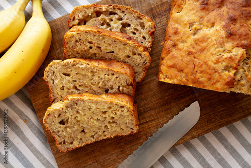Homemade Banana Bread on a wooden board, top view. Close-up.