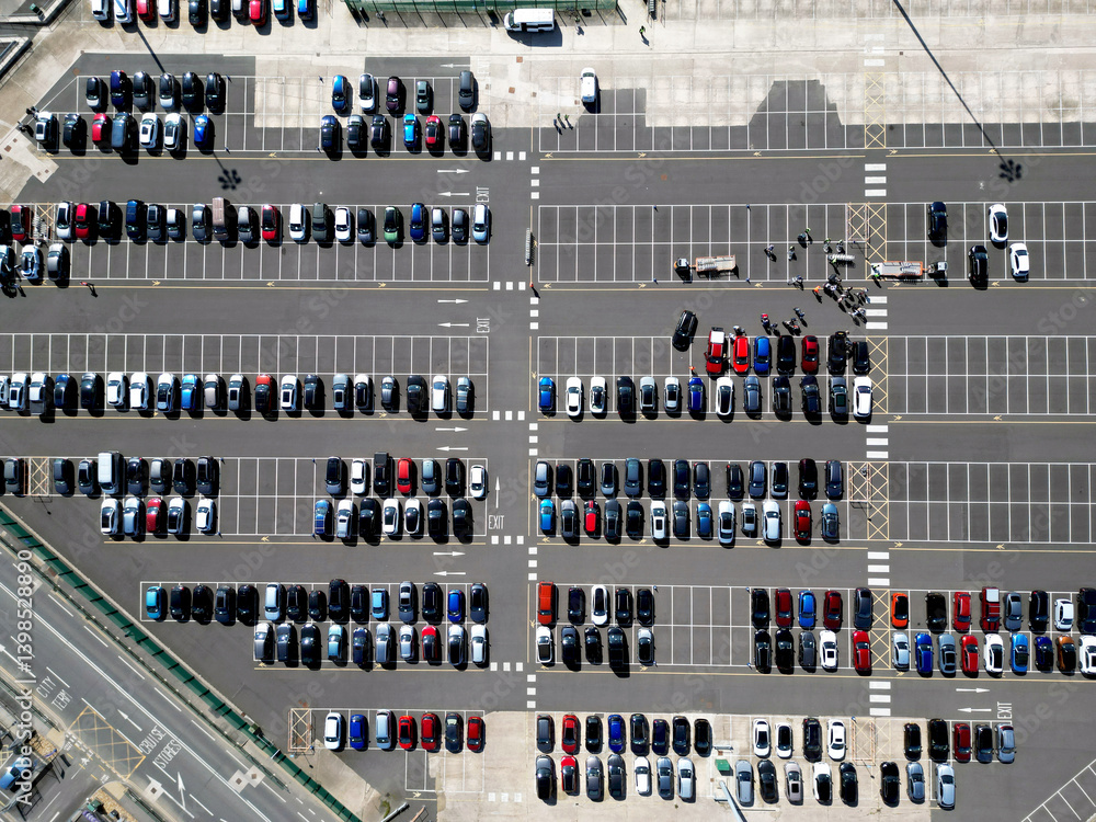 Aerial view of new cars stock at factory parking lot. Above view cars parked in a row. Automotive industry. Logistics business. Import or export new cars at warehouse. Big parking lot at port terminal Aerial view of new cars stock at factory parking lot. Above view cars parked in a row. Automotive industry. Logistics business. Import or export new cars at warehouse. Big parking lot at port terminal