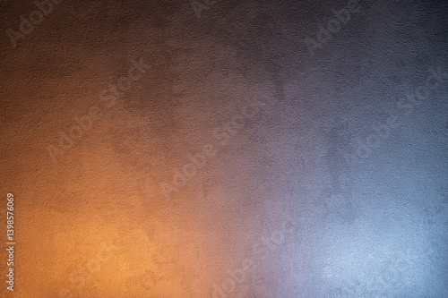 Texture of gray concrete wall with gradient lighting in warm and cold tones.