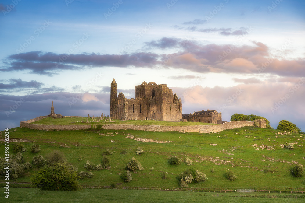 Stunning view of ancient ruins of Rock of Cashel set on a lush green hill, under a picturesque sky, ideal for travel and history enthusiasts, Tipperary, Ireland