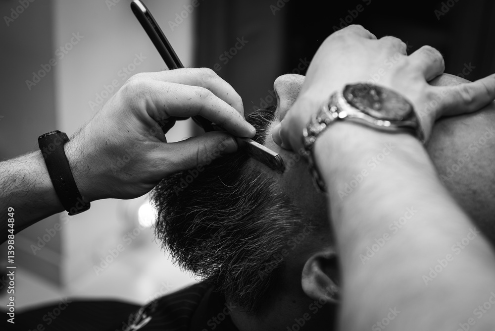 Black and white classic vintage photo, close-up, barber trimming beard with electric clipper, hair scissors in modern barbershop. Professional men's grooming and beard care services, selective focus