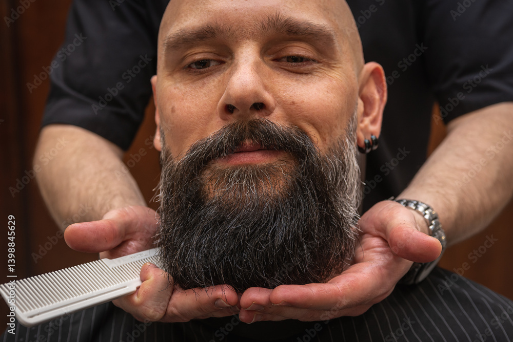 Bearded man at barbershop getting beard groomed and shaped by barber. Close-up of grooming process, professional beard care, stylish male beauty routine