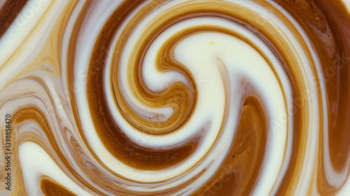 The silky blend of coffee and cream forms hypnotic patterns, capturing warmth and indulgence in every ripple.


