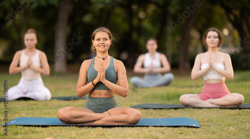 Obraz na płótnie Lotus pose - young girls doing yoga outdoors w salonie