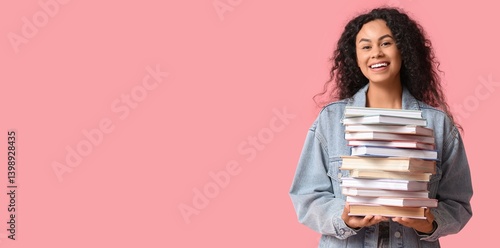 Photography Happy young African-American woman holding stack of many books on pink backgroun