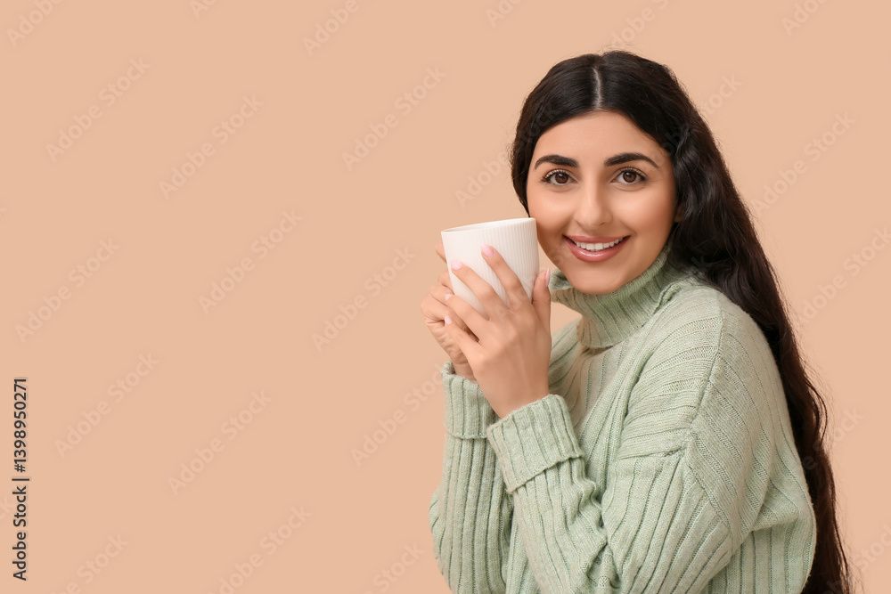 Happy young woman with cup of hot tea on beige background Happy young woman with cup of hot tea on beige background
