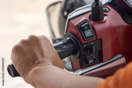 Close-up view of driving a motorbike on a rural road, Thailand