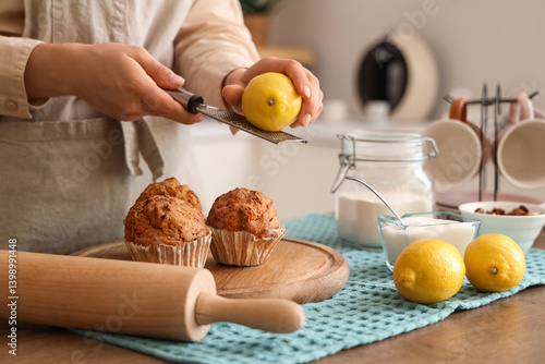 Woman grating lemon zest on...