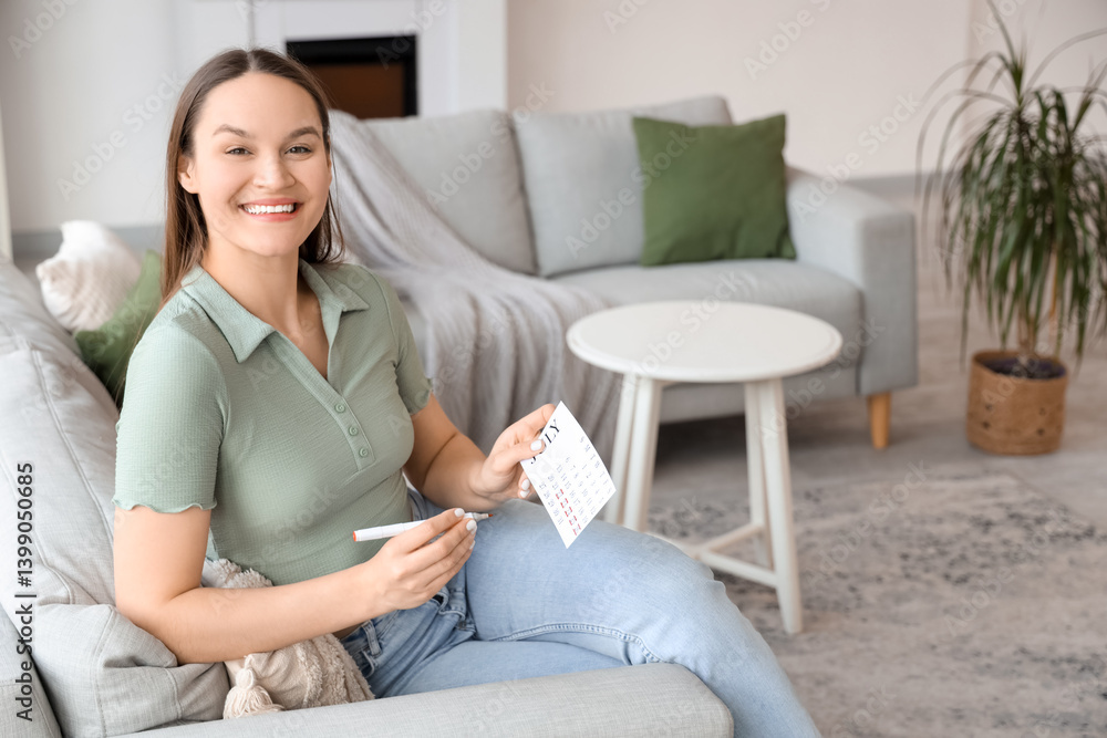 Young woman marking her period in menstrual calendar at home Young woman marking her period in menstrual calendar at home