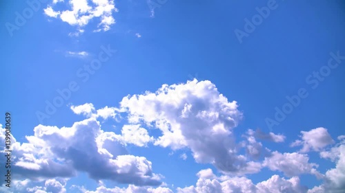 White clouds slowly float across the blue sky the bright sun shines summer timelapse 4k video footage