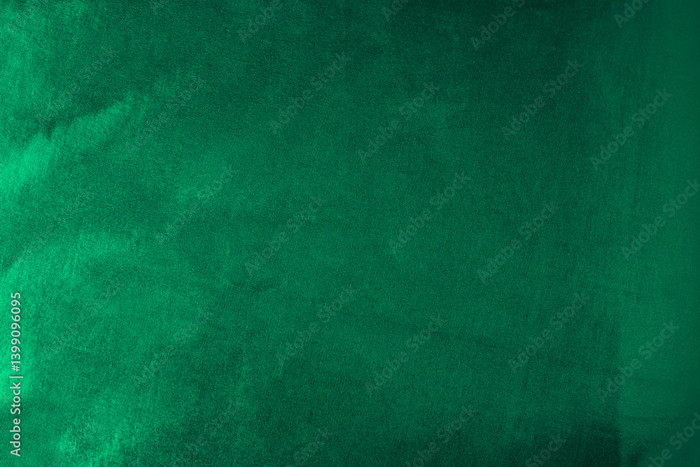 Black dark emerald green abstract background. Shiny silk fabric. Metallic shine. Light reflection.