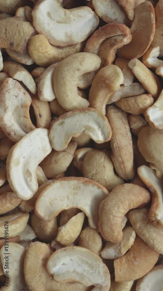 Pile of roasted cashew nuts. Crispy texture and crunchy nut. 4k vertical concept Pile of roasted cashew nuts. Crispy texture and crunchy nut. 4k vertical concept