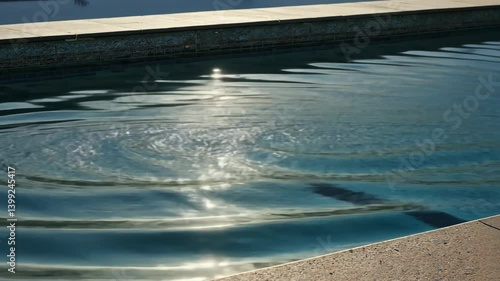 Wallpaper Mural Swimming pool water with ripples and sunlight reflecting on the surface showing light and shadow patterns, texture and clear cool liquid, summer vibes. Torontodigital.ca