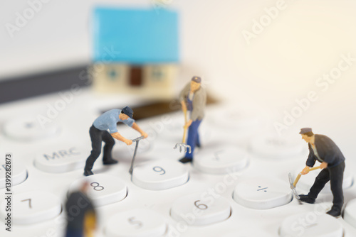 Miniature Construction Workers on a Phone Keypad Representing Home Improvement
