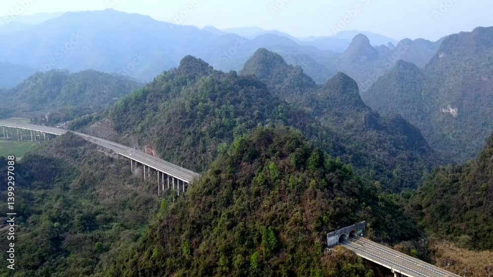 Aerial view of elevated highway in Guangxi's mountainous landscape Aerial view of elevated highway in Guangxi's mountainous landscape