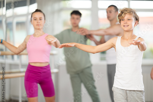 Obraz na płótnie In dance studio, teen boy in group lesson with students rehearses, practices ballet dance, staging. w salonie