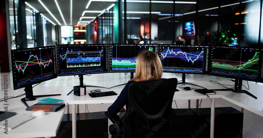 Young Female Stock Market Analyst Reviews Multiple Computer