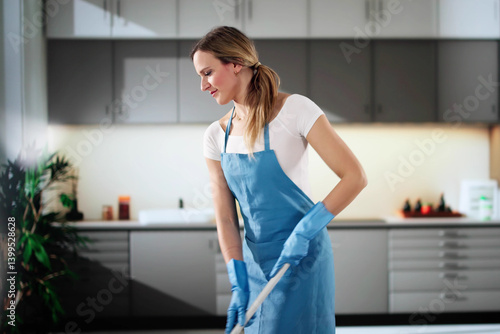 Obraz na płótnie Professional Maid Cleans Kitchen Floor With Bucket w salonie