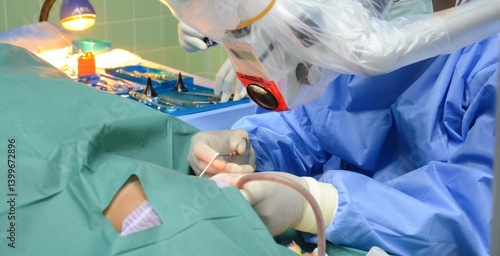 Photos Ear surgery by microsurgery, surgeon with surgical instruments, The doctor is op