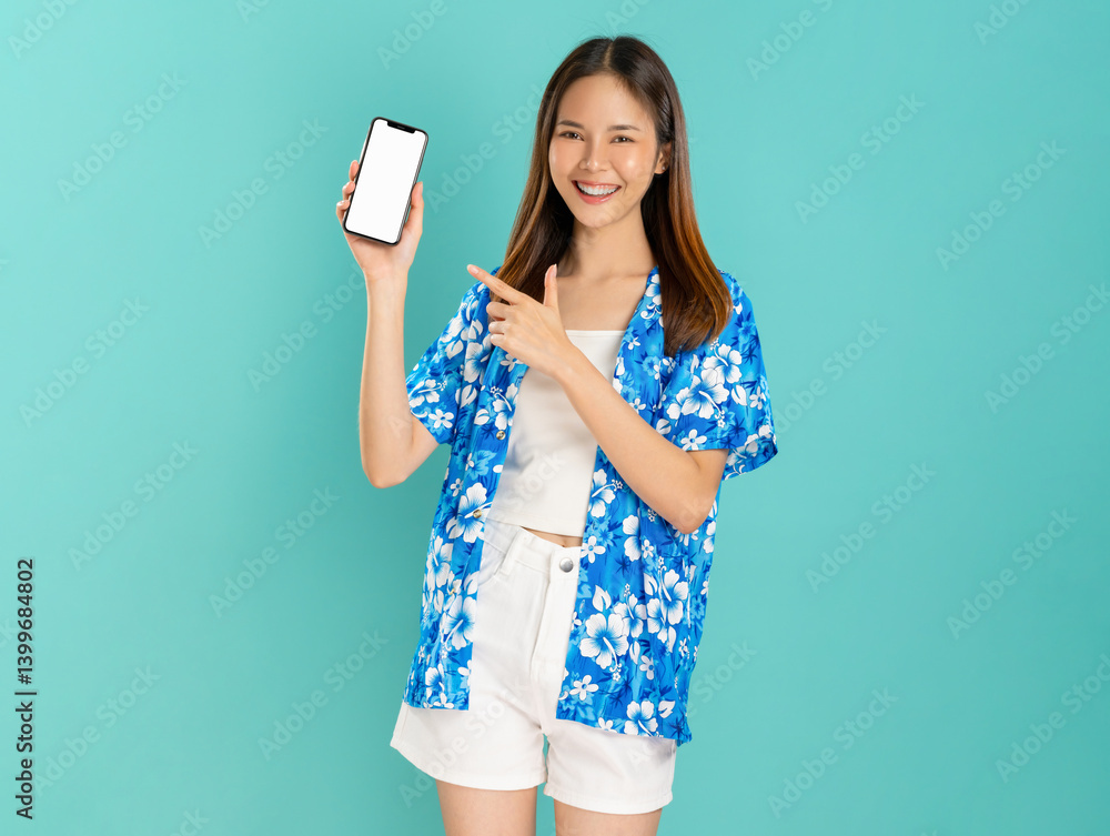 Portrait of young Asian woman in summer wearing floral shirt holding and holding smartphone mockup of blank screen and smiling on blue background. Portrait of young Asian woman in summer wearing floral shirt holding and holding smartphone mockup of blank screen and smiling on blue background.