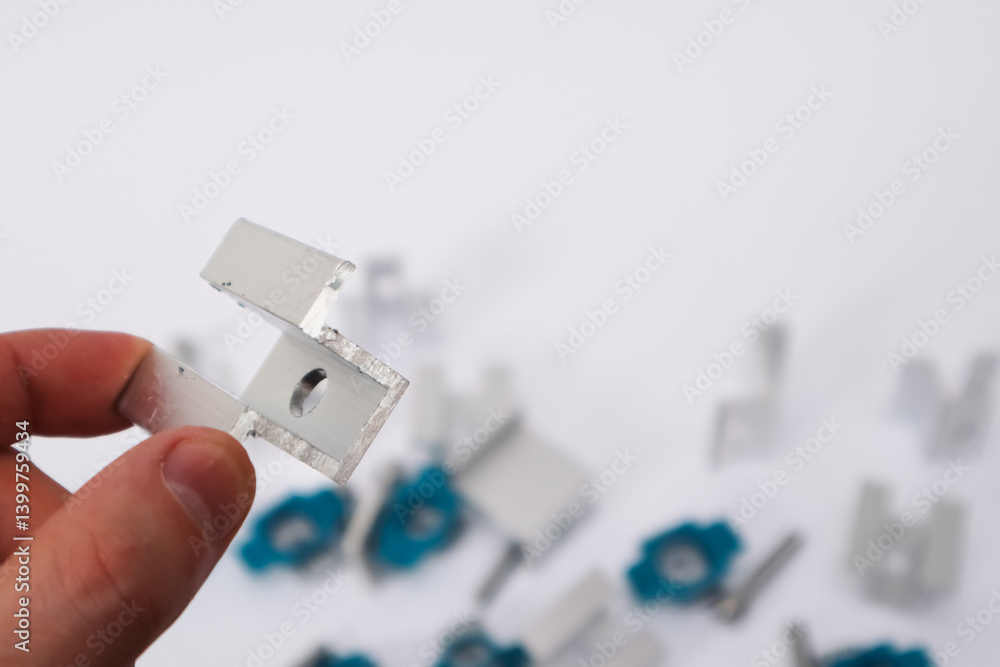 Fototapeta premium Hand Holding End Clamp of Solar PV Panel. Solar Panel Mounting.