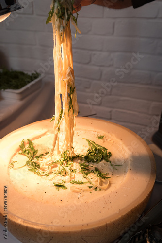 Freshly melted cheese pulled from pasta with herbs.